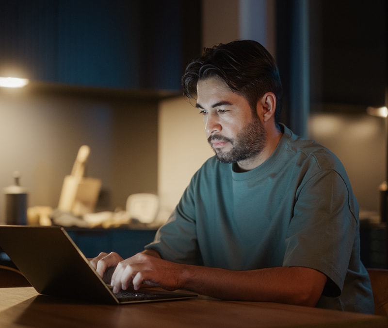 A man accesses the dark web using his laptop.