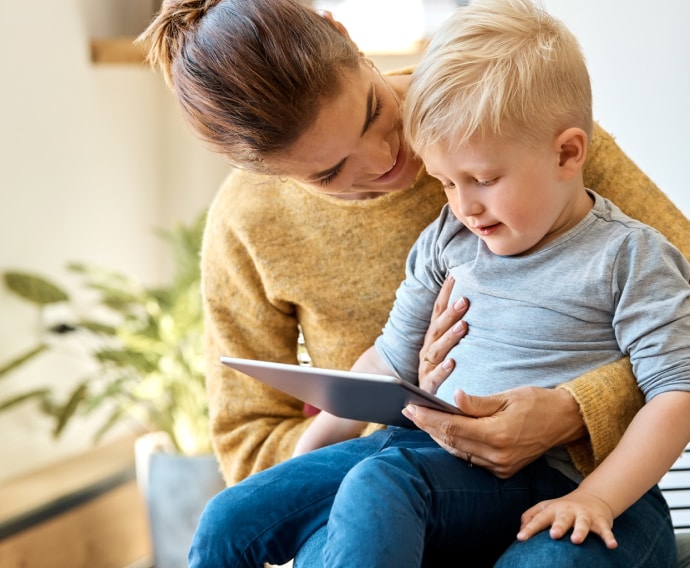 Mother with son using device